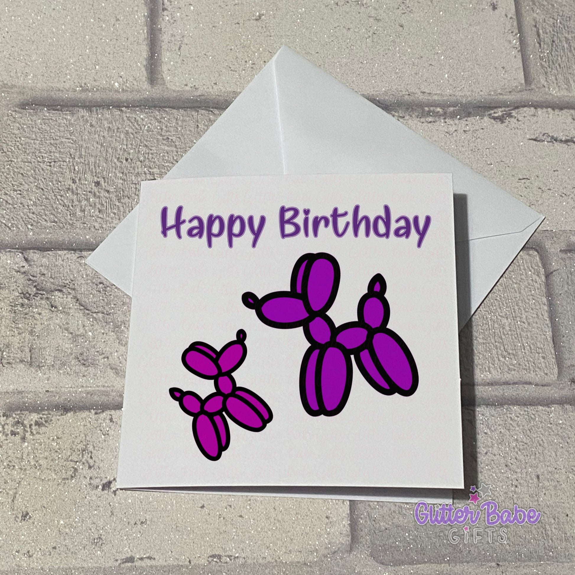 two balloon dog images on a white square card with the words happy birthday