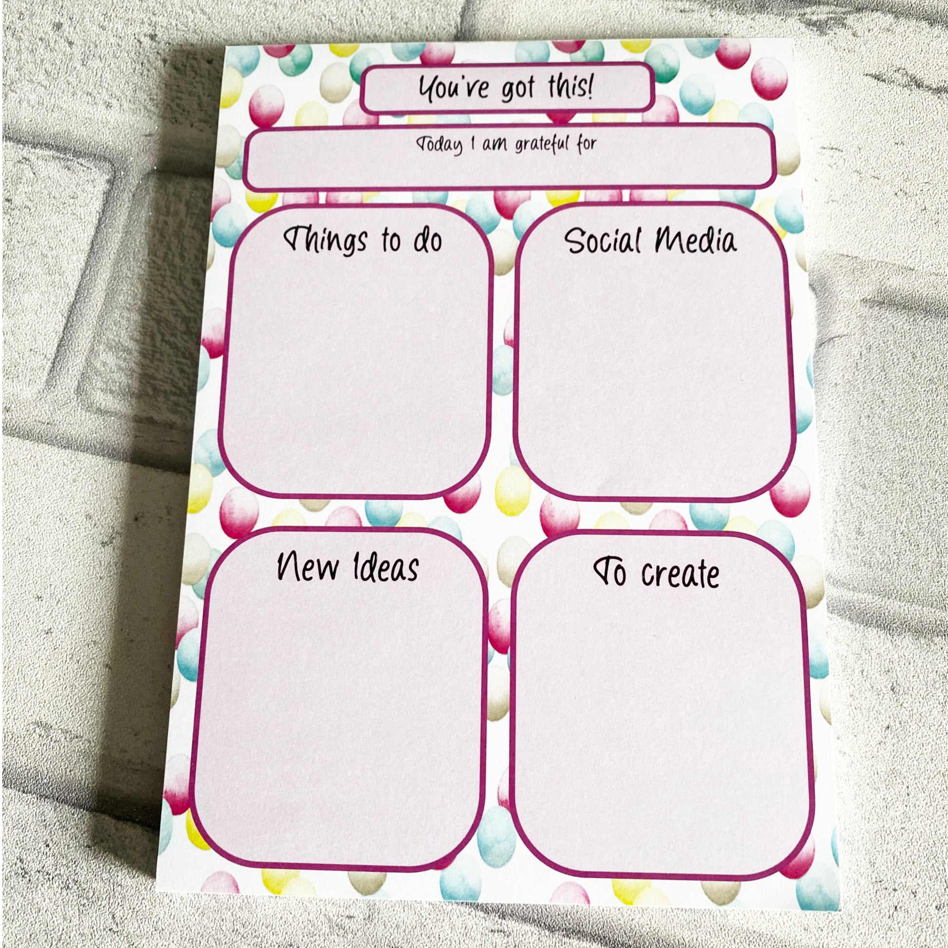 Daily Planner with colourful bubble design and sections on it for social media planning. wording You've got this  along the top. 