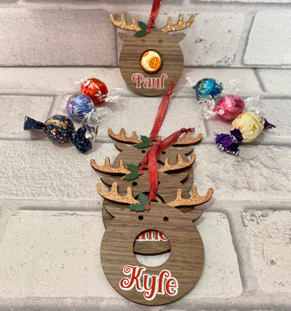 image showing  wooden baubles laying flat with chocolate sweets to the side