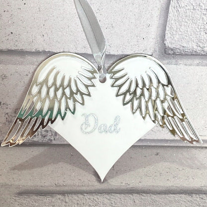 White Acrylic Heart with Silver Mirrored Acrylic wings with the Word Dad in glittery Silver Vinyl